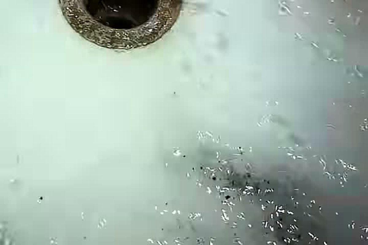 Water running over a basement floor drain during a cleaning