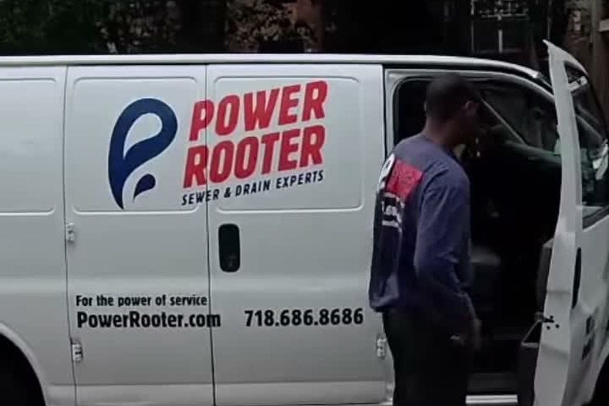Technician at the open side door of a Power Rooter van